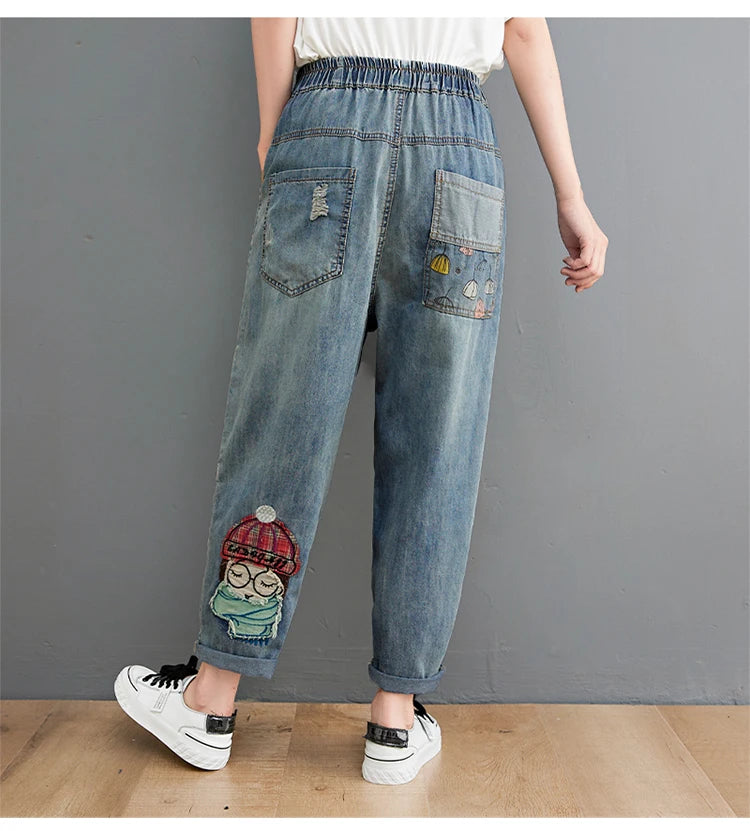 Women's Cartoon Embroidery Denim Pants – Casual High-Waist Harem Style with Pockets and Trendy Distressed Details.